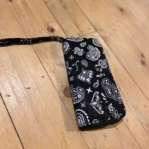 A paisley black and white clutch wallet.